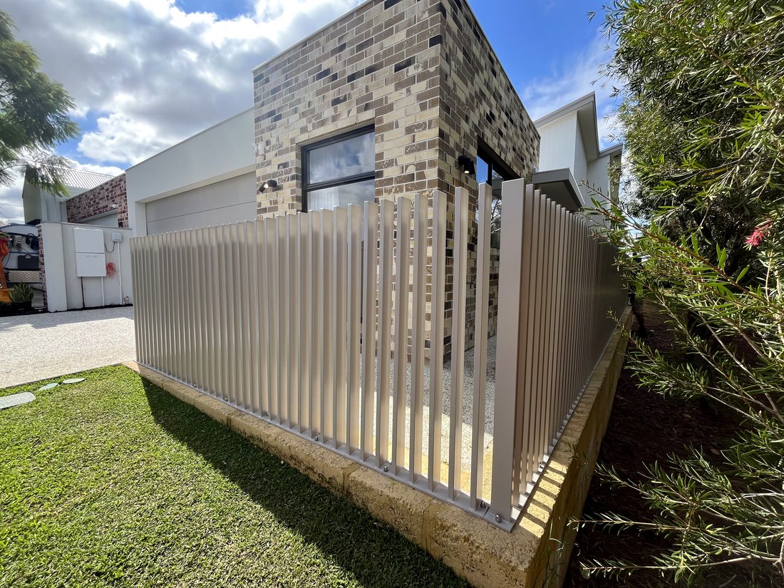 Taupe aluminium batten fence wrapping a modern brick feature wall, Carine WA