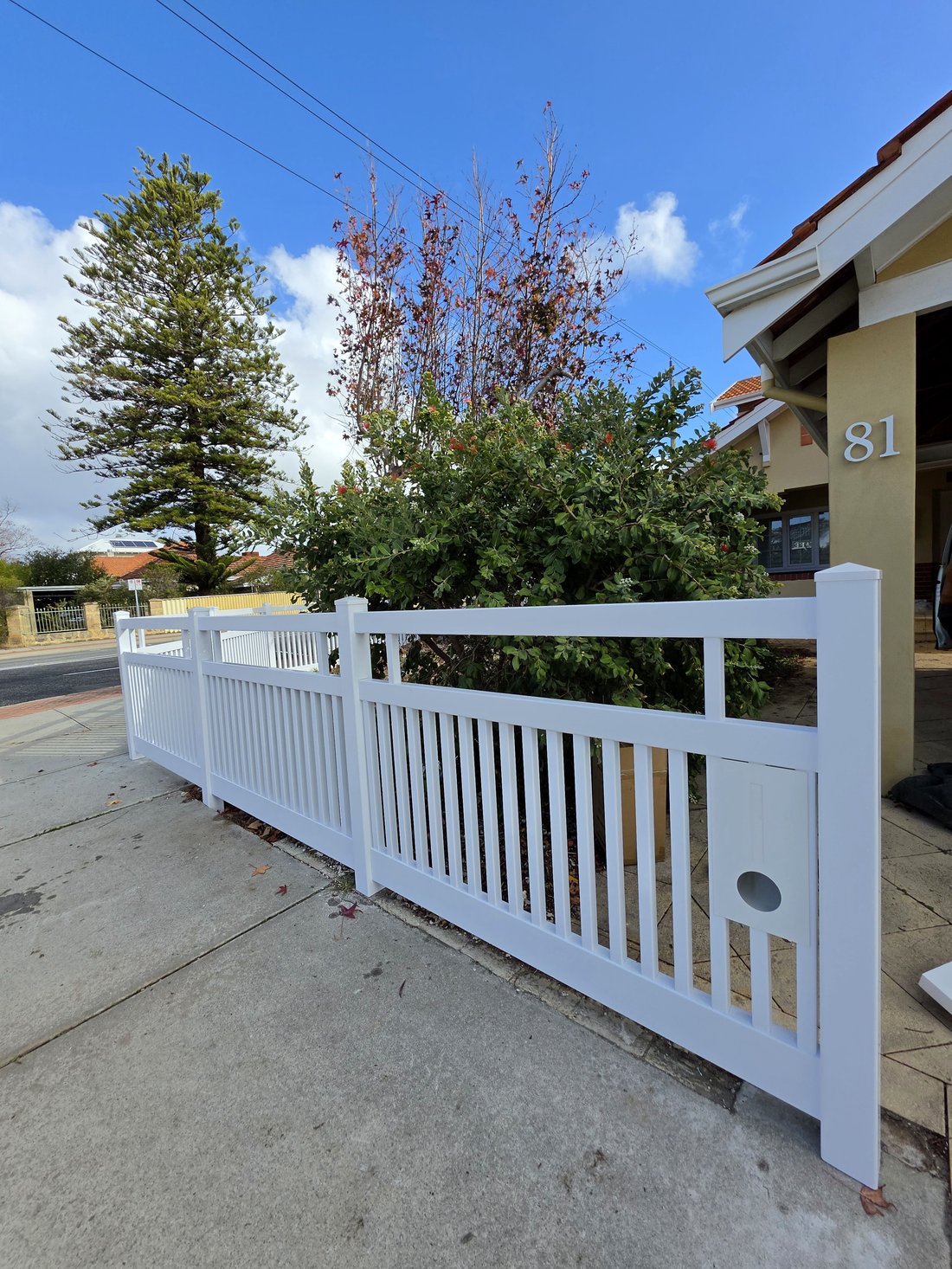 White PVC Hamptons-style picket fence with privacy base, corner view showing house number, Perth WA