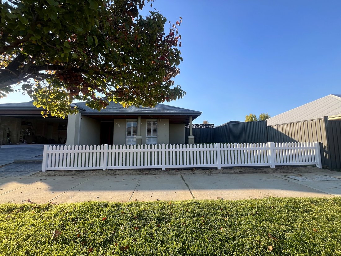 White New England style picket fence across a home's front frontage, Ellenbrook WA
