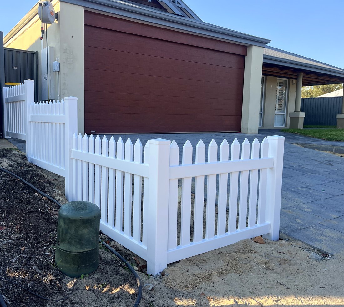 White New England style picket fence and corner gate beside a driveway, Ellenbrook WA