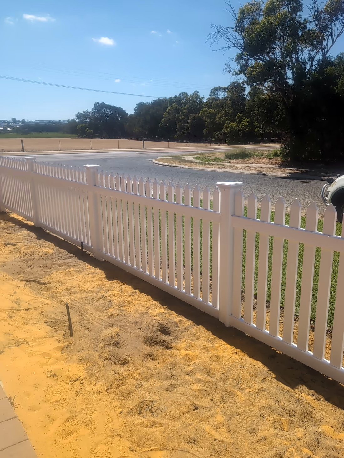 White New England style picket fence along a street corner, Perth WA