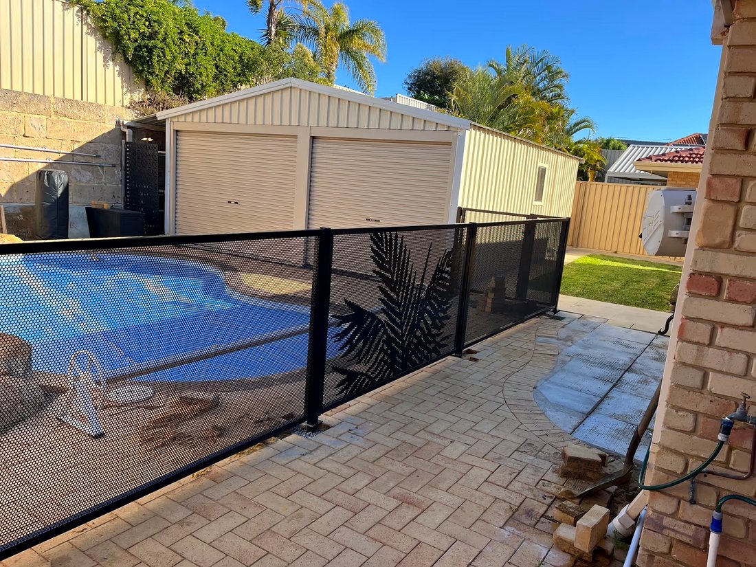Black perforated pool fencing with a decorative laser-cut palm tree panel, Currambine WA